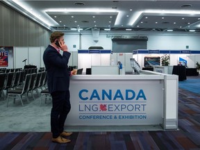 A man speaks on his phone while attending the Canada LNG Export Conference and Exhibition in Vancouver on May 12, 2016.