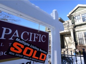 A real estate sold sign is shown outside a house in Vancouver, Tuesday, Jan.3, 2017. The Real Estate Board of Greater Vancouver says home sales across Metro Vancouver were steady but more "historically normal" in 2017, although prices continued to climb.