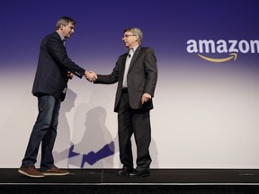 Tom Gebhardt, right, chairman and CEO of Panasonic Corp. of North America, shakes hands with Amazon's Tom Taylor after watching a presentation during a news conference at CES International, Monday, Jan. 8, 2018, in Las Vegas.