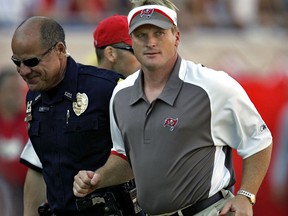 FILE - In this Sunday Nov. 4, 2007 file photo, Tampa Bay Buccaneers head coach Jon Gruden, right, leaves the field after an NFL football game against the Arizona Cardinals in Tampa, Fla. Jon Gruden says he hopes he's a candidate to return for a second stint as coach of the Oakland Raiders and believes a final decision will be made next week. Gruden made his most specific comments about the opening in Oakland created when the Raiders fired Jack Del Rio following a disappointing six-win season in an interview Tuesday, Jan. 2, 2018 with the Bay Area News Group.