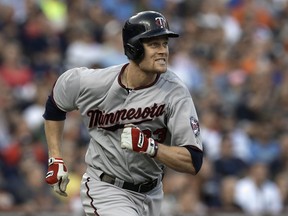 FILE - In this Aug. 21, 2013, file photo, Minnesota Twins' Justin Morneau runs after hitting a double against the Detroit Tigers in the third inning of a baseball game in Detroit.