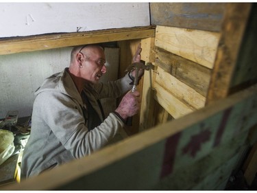 Jay Post works on the home he made from a shipping container.
