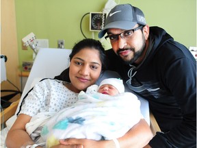 First-time parents mom Manpreet Nijjar-Shergill and dad Hardip Shergill are pictured with their new, yet-to-be-named baby girl at Surrey Memorial Hospital in Surrey, BC., January 1, 2018. The baby girl was delivered nine seconds past midnight and weighed 8 pounds and 7 ounces. The baby is the first one born in B.C. in 2018.