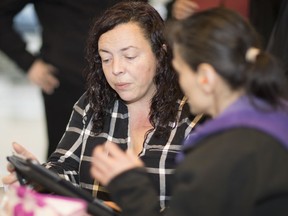 Dionne Pelan, left, a co-ordinator with the Learning Exchange, helps a local resident Friday in the DTES. For more than a year, the DTES Adult Literacy Roundtable and University of B.C. Learning Exchange have been providing free training at a 'technology cafe' at the Oppenheimer Park Field House.