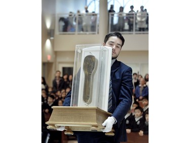 The relic of the forearm and hand of Jesuit priest St. Francis Xavier is carried in to St. Francis Xavier Church in Vancouver