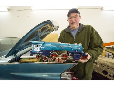 Alan Ketcheson holds up a model of a Lionel I-400E locomotive belonging to the late Alan Cruickshank.