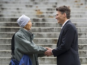 Mayor Gregor Robertson stops to chat with a constituent prior to addressing the media after his announcement that he will not run for reelection.