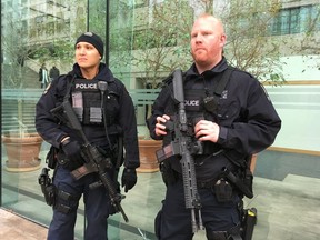 Two officers stand guard outside the Vancouver courthouse, where gangster Jamie Bacon was denied bail Tuesday. He will remain in custody pending his trial in April for charge of counseling murder. Photo: Mike Bell, Postmedia [PNG Merlin Archive]