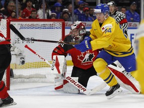 Sweden forward Lias Andersson (24) skates past Canada goalie Carter Hart (31) during the first period in the gold medal game of the world junior hockey championships.
