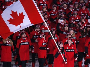 The Canadian delegation, led by flag bearers Tessa Virtue and Scott Moir, marches into the opening ceremony at the Pyeongchang Olympics on Feb. 9.