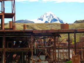 The rusted beams of a former whale processing plant at Grytzviken, South Georgia are silhouetted against a glacier.