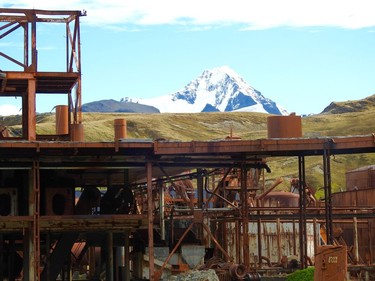 The rusted beams of a former whale processing plant are silhouetted against a glacier at Grytzviken, South Georgia.