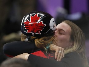 Kim Boutin, left, hugs Marianne St Gelais after she won silver in the women's 1,000 metres on Feb. 22.