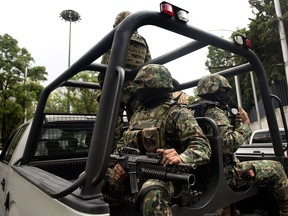 Mexican Navy marines patrol in a truck.