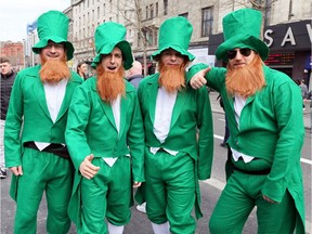 Revellers dressed as leprechauns pose for a photo.