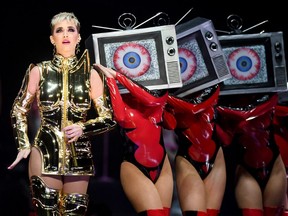 Singer/songwriter Katy Perry (L) performs with dancers during a stop of Witness: The Tour.