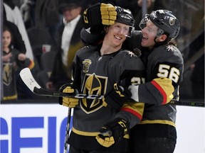Erik Haula of the Vegas Golden Knights, right, hugs teammate Cody Eakin after their 7-3 victory over the Calgary Flames at T-Mobile Arena on Feb. 21 in Las Vegas.