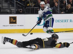 Sam Gagner #89 of the Vancouver Canucks passes for an assist over Luca Sbisa #47 of the Vegas Golden Knights in the first period of their game at T-Mobile Arena on February 23, 2018 in Las Vegas, Nevada.