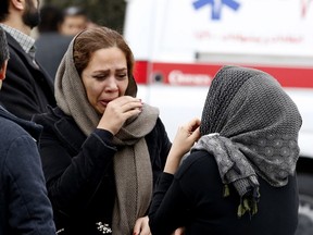 Relatives of Iranian passengers, onboard the Aseman Airlines flight EP3704, react as they gather in front of a mosque near Tehran's Mehrabad airport on February 18, 2018. All 66 people on board an Iranian passenger plane were feared dead after it crashed into the country's Zagros mountains, with emergency services struggling to locate the wreckage in blizzard conditions.