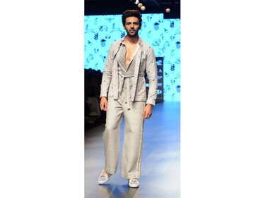 Indian Bollywood actor Kartik Aaryan showcases a creation by designer Crow at the Lakmé Fashion Week (LFW) Summer Resort 2018 in Mumbai on February 4, 2018.