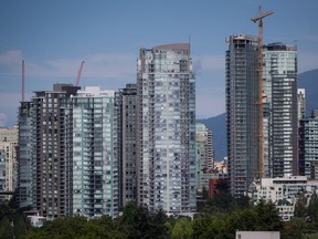 Condo towers, including one under construction, right, are seen in downtown Vancouver, B.C., on August 15, 2017.