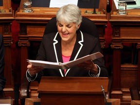 Finance Minister Carole James shares a laugh with a colleague before delivering the budget speech from the legislative assembly at Legislature in Victoria.