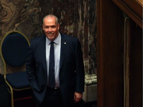 B.C. Premier John Horgan was all smiles before the budget speech in Victoria on Tuesday, Feb. 20. Alberta Premier Rachel Notley said he "blinked" later in the week on the so-called trade war between the provinces.