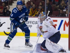 The Canucks' Brock Boeser watches the puck head for Florida Panthers goalie James Reimer in a regular-season NHL game at Rogers Arena in Vancouver on Feb. 18.