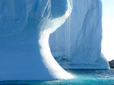 PARADISE BAY, Antarctica – Water cascades down from an iceberg in the waters off the Antarctic Peninsula of Paradise Bay where minke and humpback whales, penguins and seals are all feeding on krill in advance of the coming winter.
