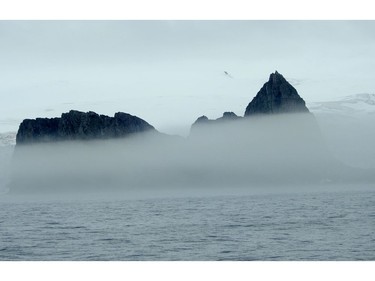 The peaks of Elephant Island pokes through the fog.