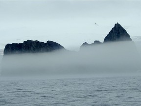 The peaks of Elephant Island poke through the fog.