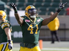 Edmonton Eskimos' Odell Willis, right, celebrates a tackle against the B.C. Lions during a 2015 game in Edmonton. Willis was traded to the B.C. Lions on Friday, as the Leos added a proven all-star to their defensive line.