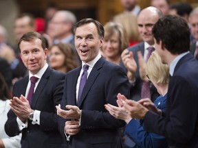 Finance Minister Bill Morneau gets an ovation as he arrives in the House of Commons prior to tabling the federal budget in Ottawa on Tuesday, Feb.27, 2017.