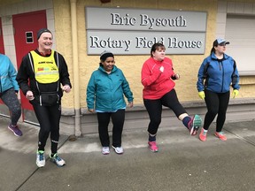 Langley Sun Run InTraining leader Gary McGregor, left, now in his 17th year of helping runners and walkers get in shape for the annual 10K road race, puts his crew through a warm-up session at McLeod Athletic Park on Feb. 3.