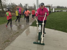Crystal Yarych-Pudsey does a quick workout while her running mates with the Langley Sun Run InTraining Clinic shuffle by near the Derek Doubleday Arboretum on Saturday, Feb. 17.
