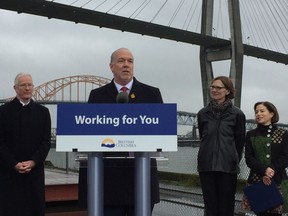 Premier John Horgan announces that the provincial government will build the new Pattullo Bridge and be responsible for owning and operating the new bridge, which will be constructed by 2023. He is flanked by (from left) Mayors' Council vice chair Richard Walton, Minister of Transportation and Infrastructure Clare Trevena and Minister of Municipal Affairs Selina Robinson.