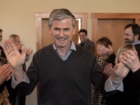 Andrew Wilkinson gets high-fived while entering his first caucus meeting as the new B.C. Liberal party leader in West Kelowna on Friday.