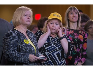 A supporter of candidate Dianne Watts covers her ears as Chinese lion dancers perform as B.C. Liberal Party members and supporters await the results of a leadership vote in Vancouver, B.C., on Saturday February 3, 2018.