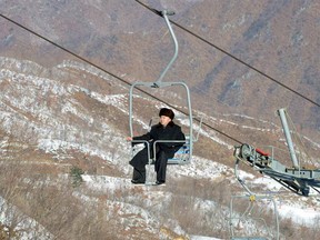 During a 2013 inspection, North Korean dictator Kim Jong-un rides a ski lift at Masikryong resort, North Korea's only ski hill.