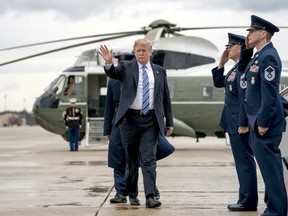 U.S. President Donald Trump waves as he boards Air Force One at Andrews Air Force Base, Md., Friday, Feb. 16, 2018, to travel to Palm Beach International Airport in West Palm Beach, Fla. (AP Photo/Andrew Harnik)