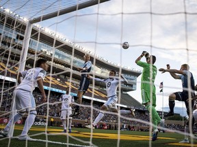 Minnesota United goalkeeper Bobby Shuttleworth (33) blocks a header off a corner kick by Vancouver Whitecaps midfielder Brek Shea (20) during the second half of an MLS soccer match Saturday, June 24, 2017, in Minneapolis.