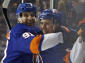 New York Islanders center John Tavares (91) celebrates with teammate Tanner Fritz (56) after Fritz scored his first career NHL goal during the second period of an NHL hockey game against the Minnesota Wild in New York, Monday, Feb. 19, 2018.