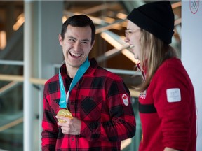 Olympic gold medalists, figure skater Patrick Chan, left, of Toronto, and freestyle skier Cassie Sharpe, of Comox, B.C., share a laugh after arriving from South Korea at Vancouver International Airport in Richmond, B.C., on Monday February 26, 2018.