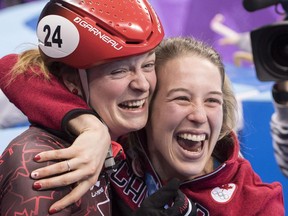 Kim Boutin (left) celebrates her 500-metre Olympic short track gold medal with teammate Marianne St-Gelais on Feb. 13.