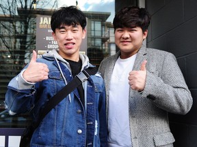 Koreans Youchan Park, left, and YongJin Park are pumped up on Robson Street in Vancouver on Feb. 8 about the Winter Olympics being in their home country.
