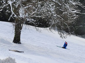 Revellers enjoy the snowy weather at Burnaby Mountain Park in Burnaby, Feb. 18, 2018.