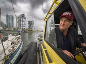 Shawn Wilson pilots  his 'rescue' boat in False Creek.