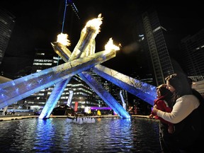 Vancouver's Olympic cauldron lit up at night at Jack Poole Plaza.
