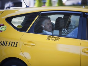 A passenger in a taxi in downtown Vancouver, British Columbia, Monday, August 21, 2017.