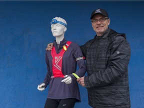 Paul Williams, the owner of Peninsula Runners and a two-time Vancouver Sun Run champion, shows off some safety gear for runners in his White Rock store.